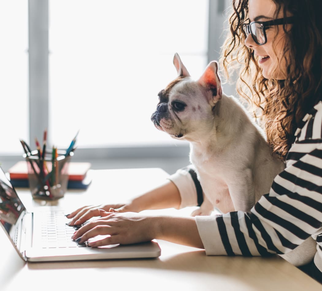 Resident and her pup surfing the web in their new home at Ingleside Apartments in North Charleston, South Carolina