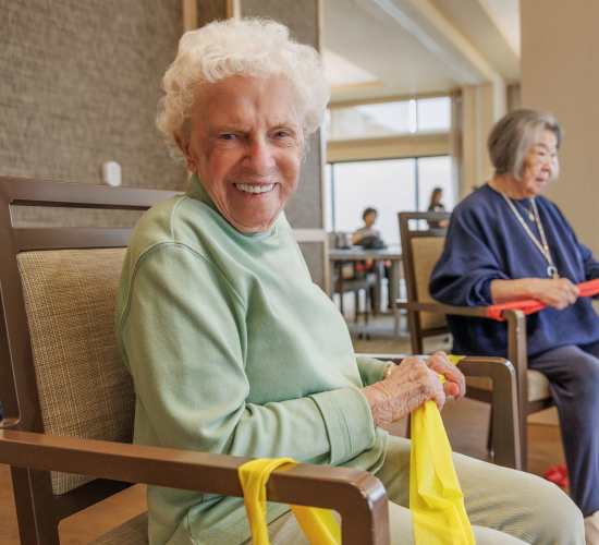 Resident friends playing putt putt golf at Merrill Gardens at Renton Centre in Renton, Washington