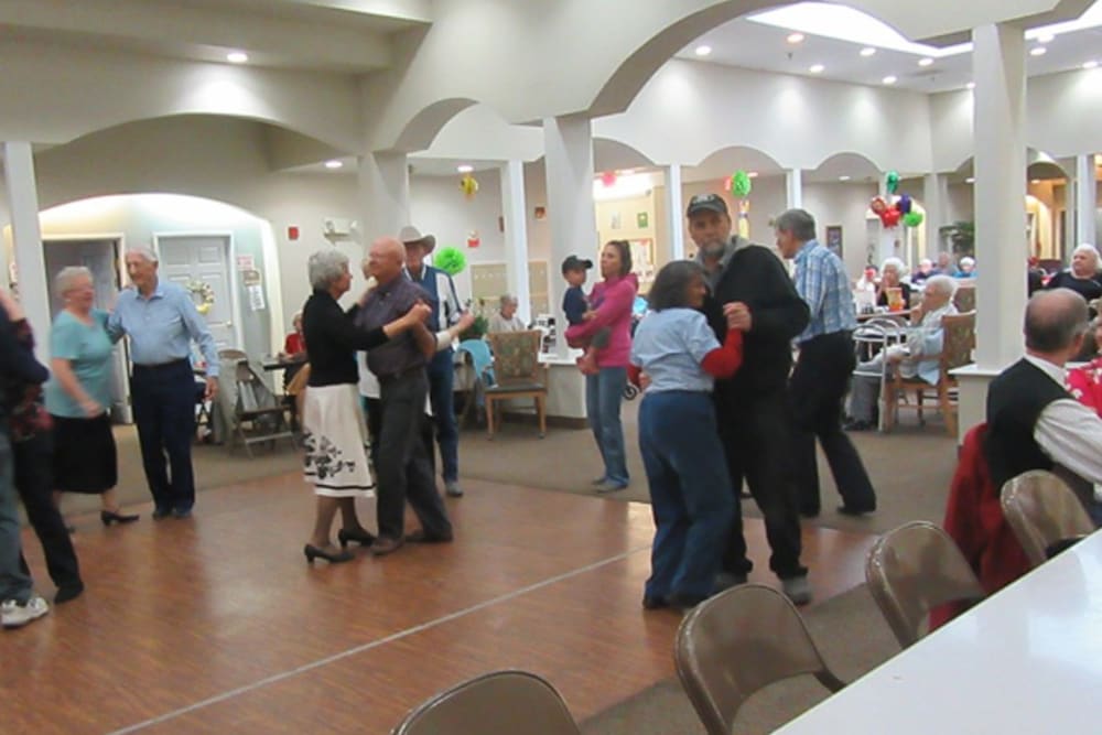 Residents dancing with their family and friends at The Peaks at South Jordan Memory Care