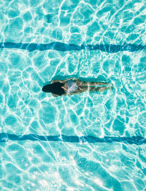 A woman swimming in the pool at Marina Del Sol in Sunny Isles Beach, Florida