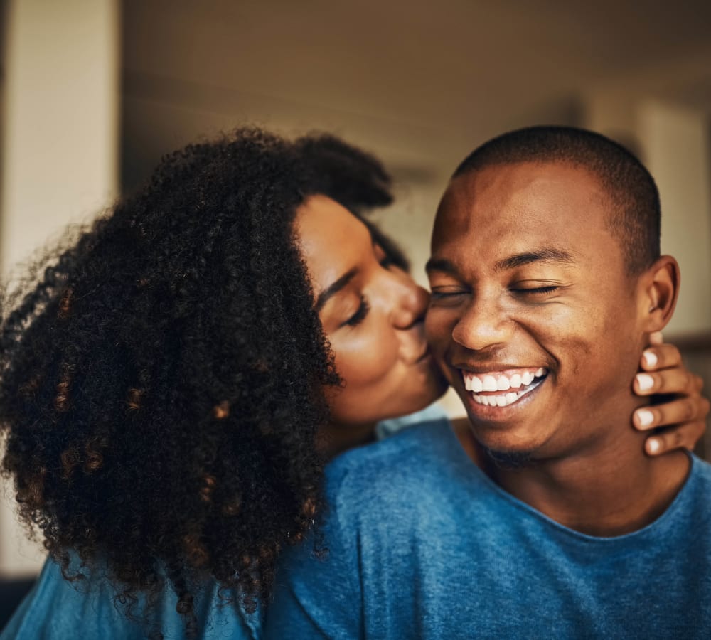 Residents sharing a happy moment and kissing in their new home at Anson in Burlingame, California