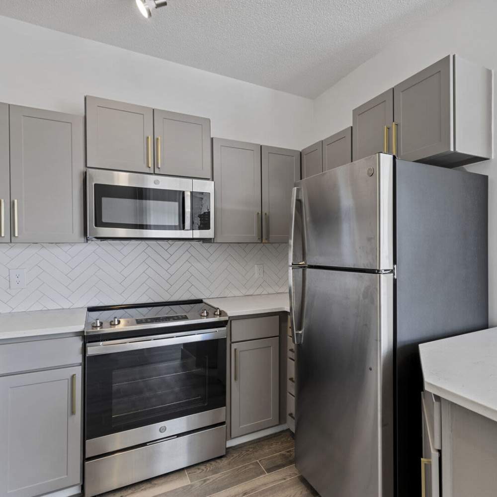 Kitchen with range and refrigerator at Chandler At University Tower in Durham, North Carolina