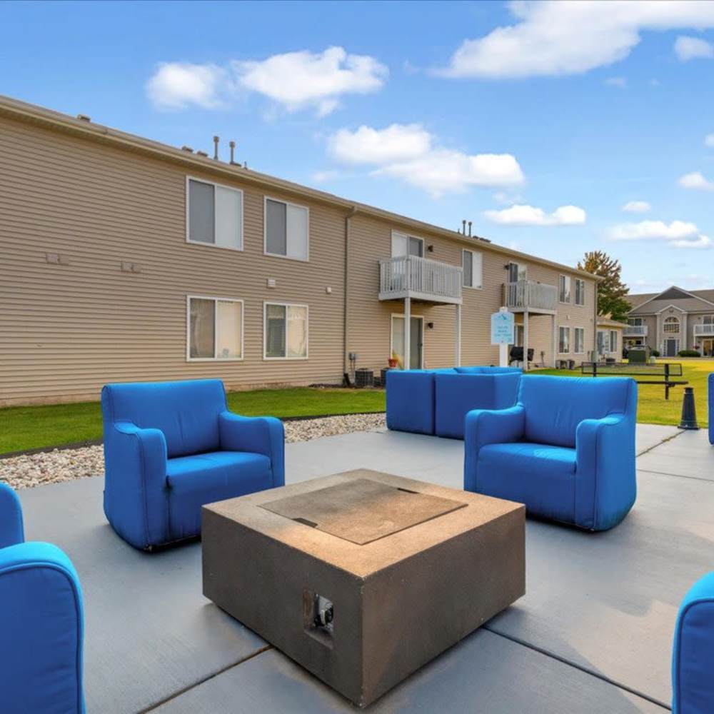 Outdoor fire pit lounge with seating at River Club in Holland, Michigan
