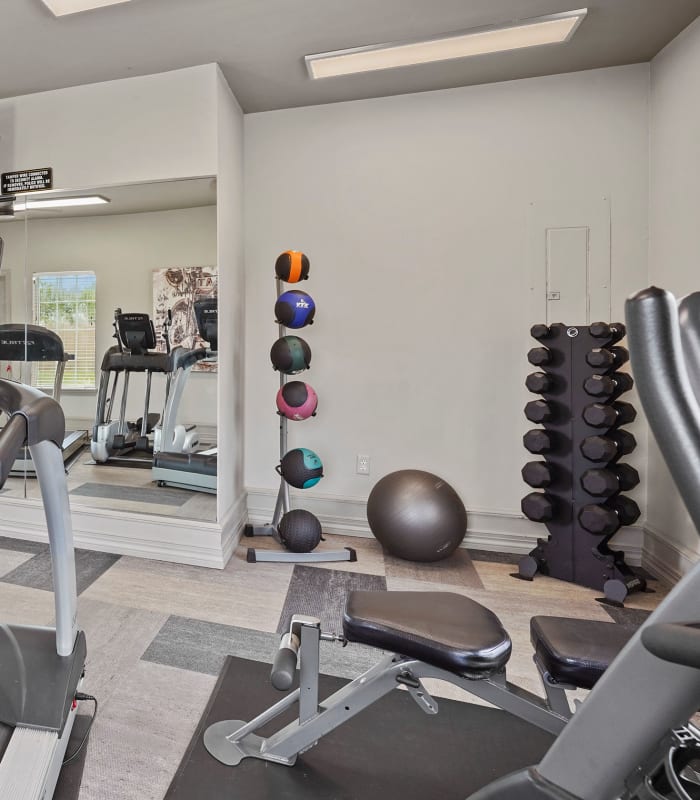 Fitness center with weights  at The Remington Apartments in Wichita, Kansas