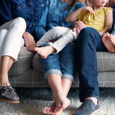 Happy family on the couch in their new home at Terra Camarillo in Camarillo, California