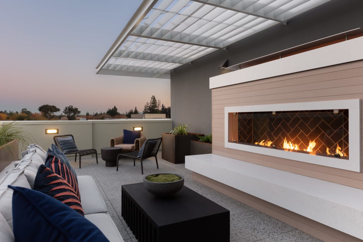Roof terrace lounge fireplace at AltaLocale Apartments in Palo Alto, CA