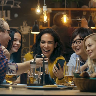 Friends socializing and enjoying drinks in restaurant nearby Marquis at Chandler in Chandler, Arizona 
