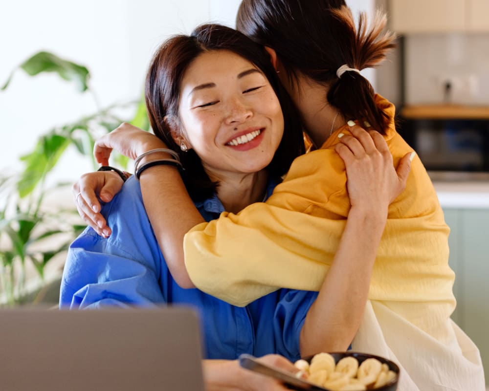 Resident getting a hug from her child at The Millton in Redwood City, California