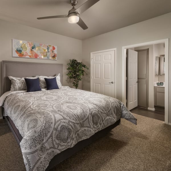 Well-decorated primary bedroom with ceiling fan and bathroom at Bellagio in Scottsdale, Arizona