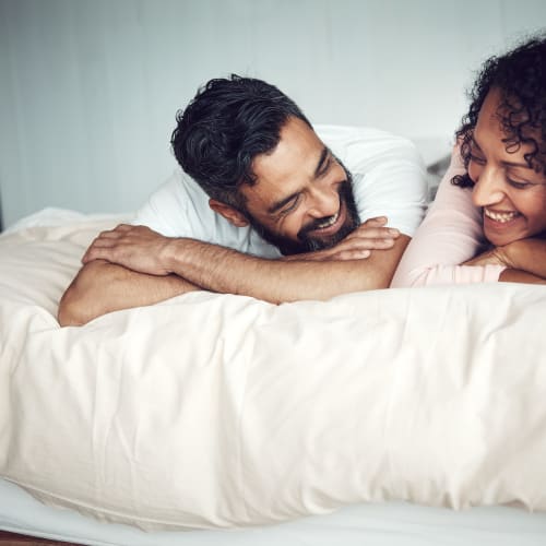 A couple laying on the bed at Ben Moreell in Norfolk, Virginia