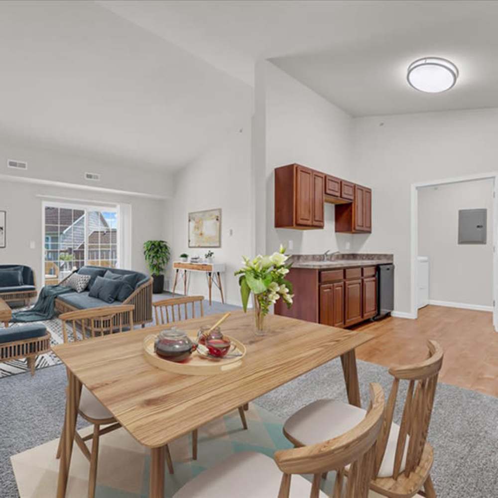 Dining table with living room view at The Haven at Grand Landing Apartments in Grand Haven, Michigan