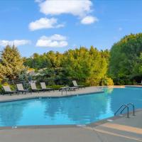 Sparkling resort-style pool surrounded by lounge chairs and lush greenery at 43 North Apartments in Grand Haven, Michigan