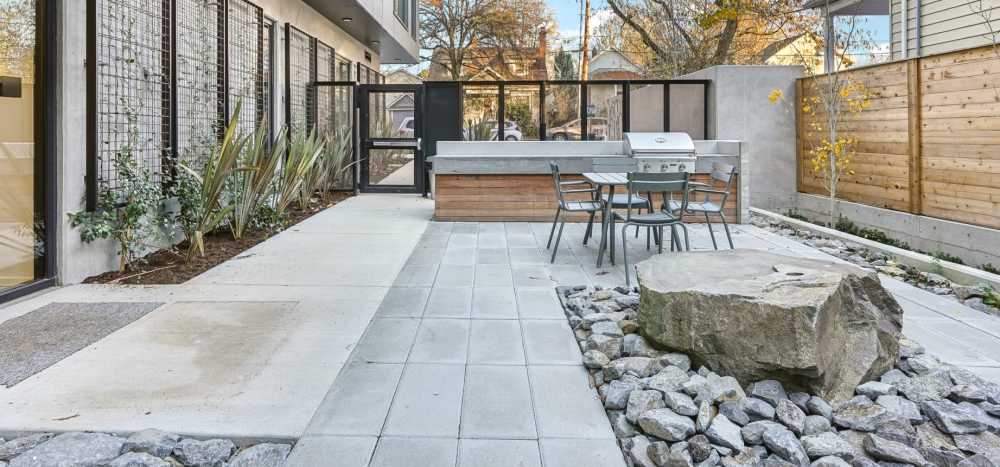 BBQ grill with outdoor seating and Zen Garden water feature at Rothko Residences in Portland, Oregon