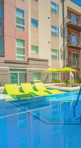 Resort-style swimming pool with sundeck at Park Place Olde Town Apartments in Arvada,Colorado