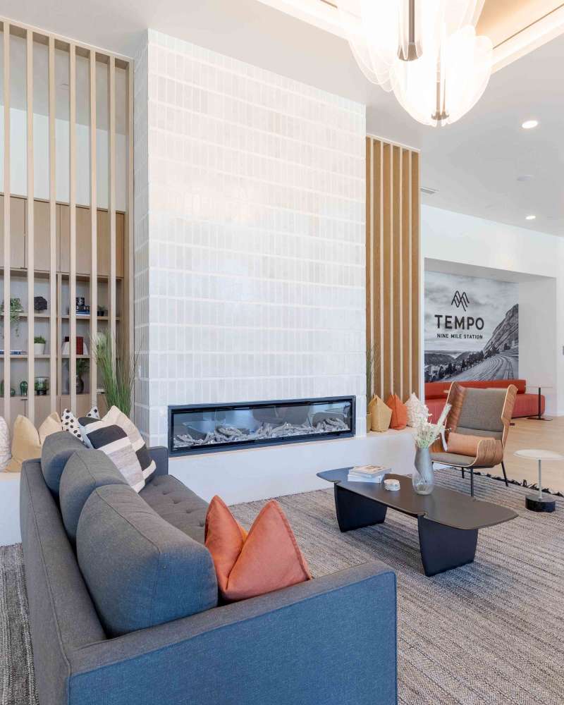 Indoor fireplace and seating area in Clubhouse at Tempo at Nine Mile Station in Aurora, Colorado