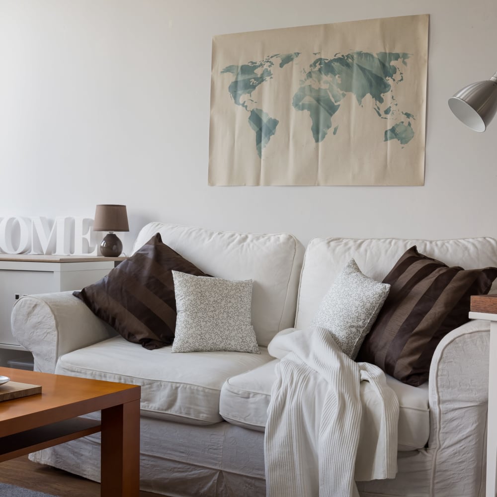 Living area with white sofa of an apartment home at Heninger Village in Santa Ana, California