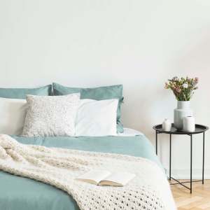 Bedroom with side table at Greer Mill Residences in Greer, South Carolina