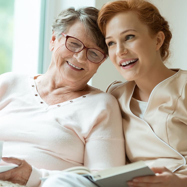 Reading a book with senior at MBK Senior Living in Irvine, California