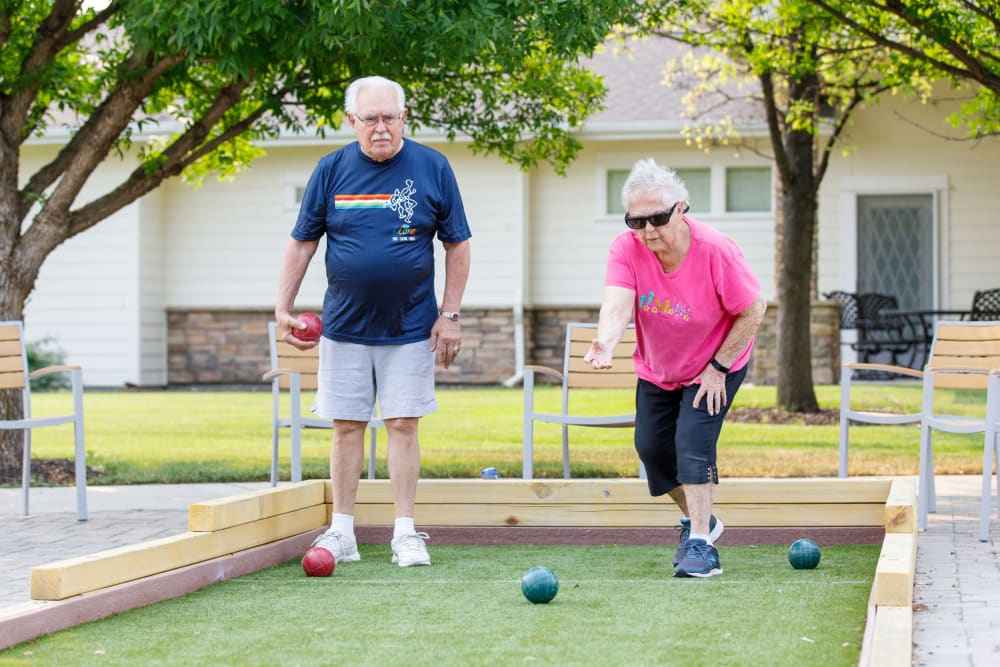 Couple playing bocce ball at Touchmark at Meadow Lake Village in Meridian, Idaho