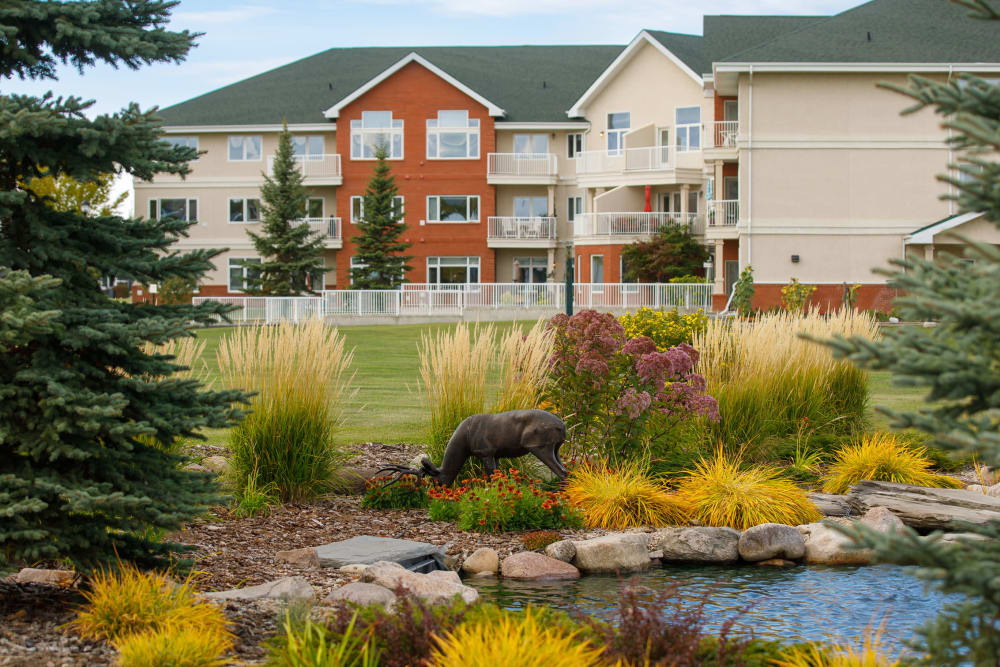 Building by creek at Touchmark at Wedgewood in Edmonton, Alberta