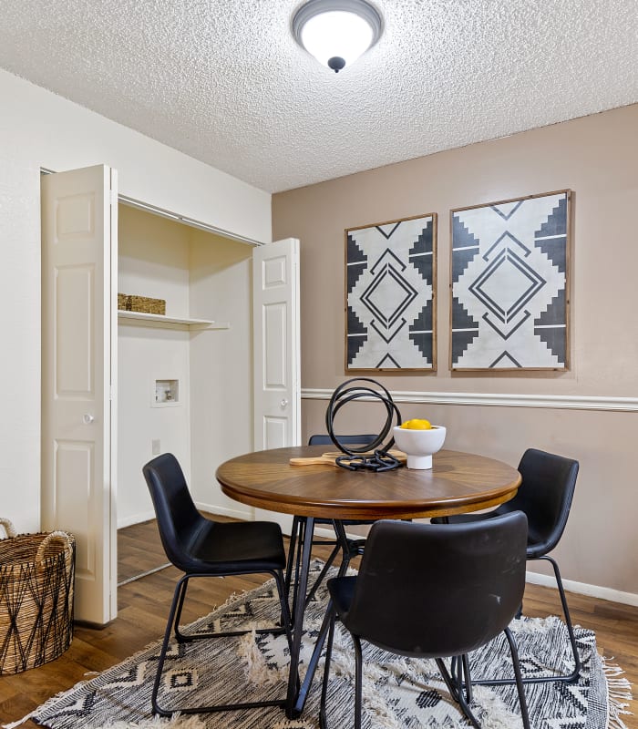 Dining area with kitchen cabinets at back at Sugarberry Apartments in Tulsa, Oklahoma