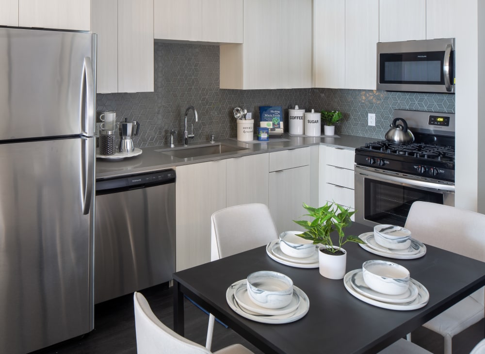 a fully equipped kitchen in an apartment at Jefferson SoLA in Los Angeles, California