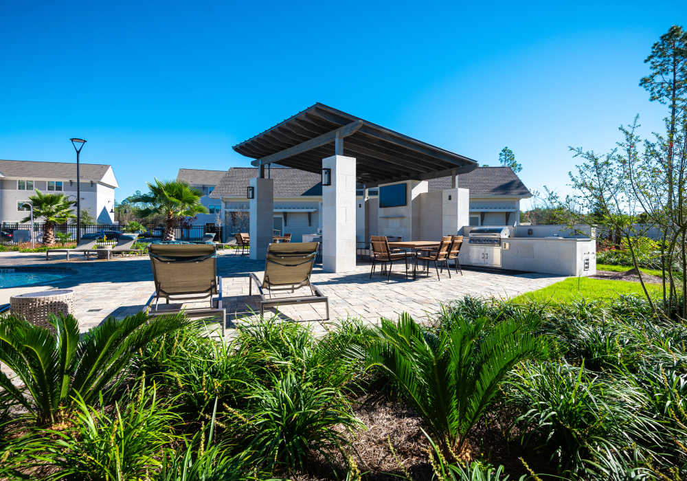 Outdoor community barbecue grills and seating at Watersound Origins Crossings in Inlet Beach, Florida