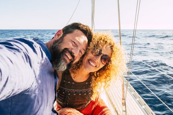 Man and woman smiling on sailboat