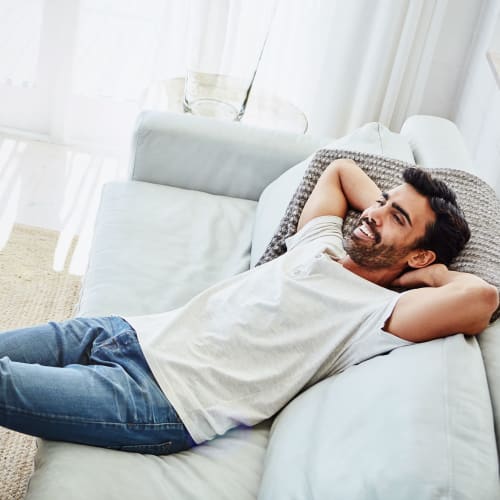 A man relaxing on the couch at Clarkdale in Joint Base Lewis McChord, Washington