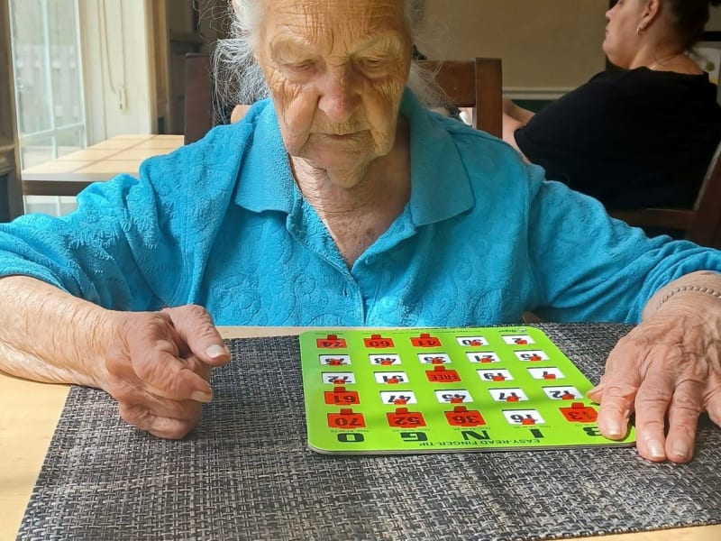 A resident playing Bingo at English Meadows Prince William Campus in Manassas, Virginia