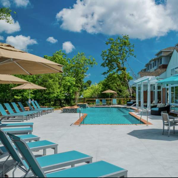 Resort-style pool with umbrellas at Promenade Pointe, Norfolk, Virginia