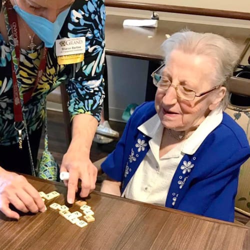 Resident showing off a painting at The Oxford Grand Assisted Living & Memory Care in McKinney, Texas