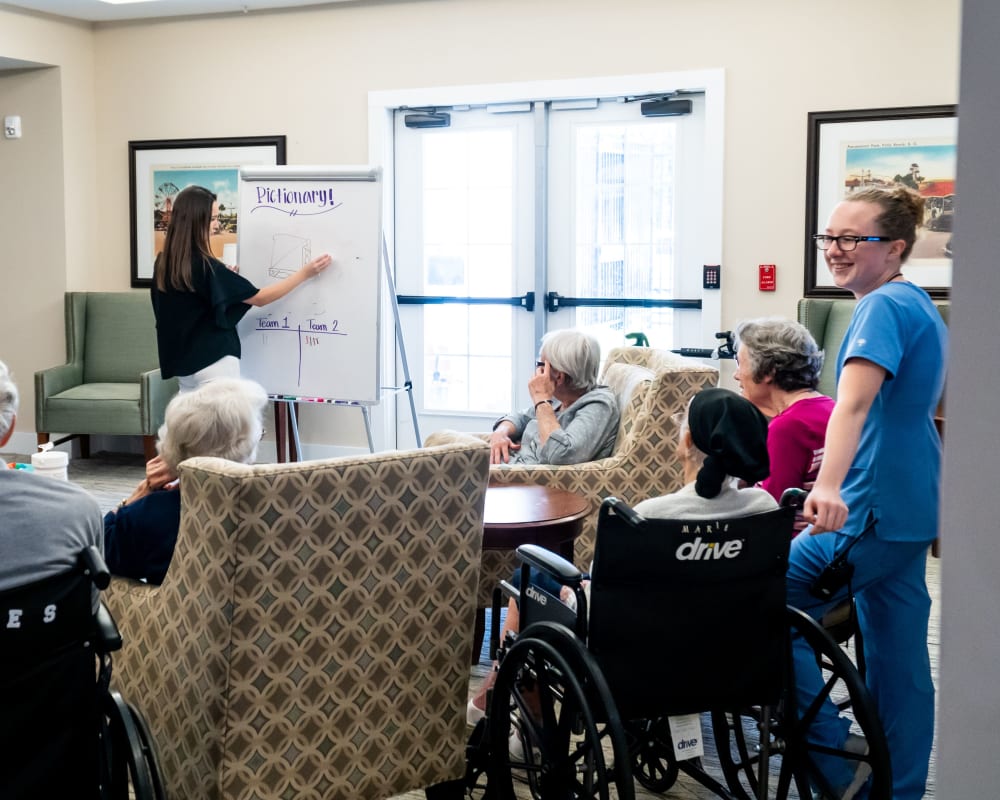 Memory care residents enjoy a game of Pictionary at Harmony at Brookberry Farm in Winston-Salem, North Carolina
