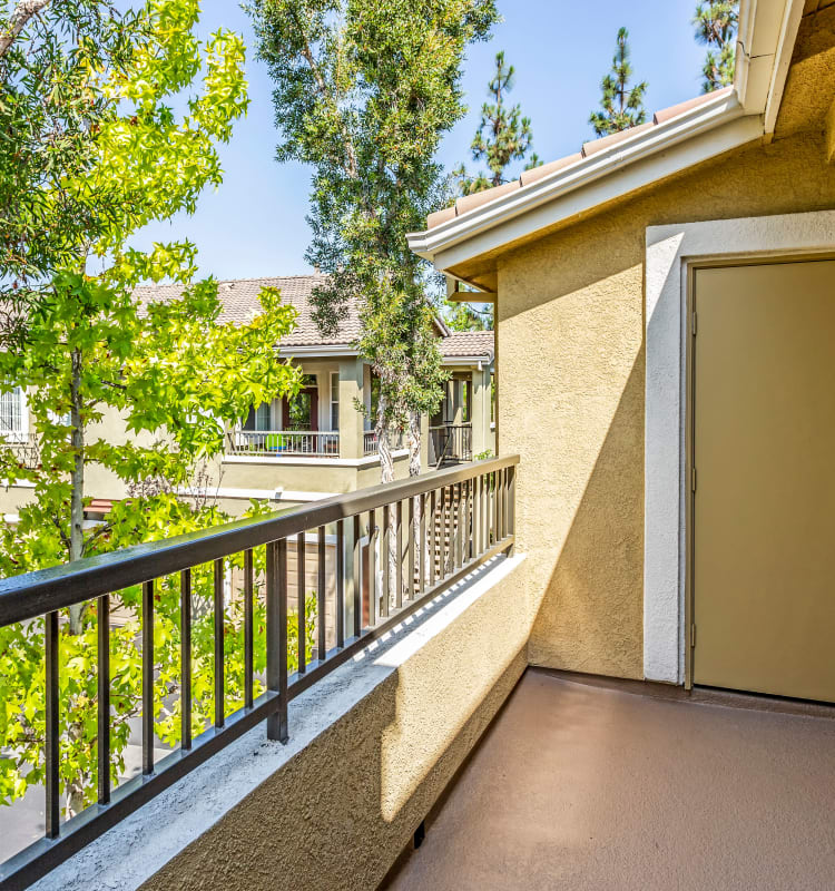 Private balcony with mature trees nearby for added privacy outside an apartment home at Sofi Highlands in San Diego, California