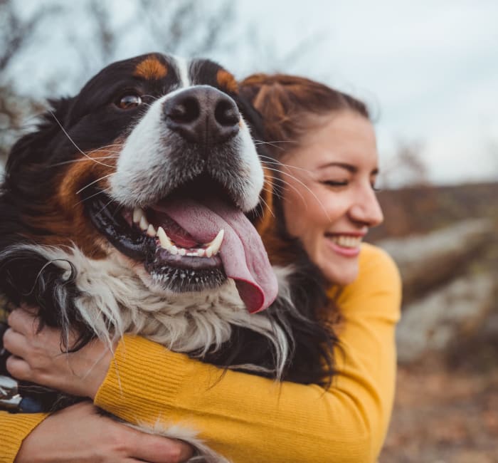 Girl giving her dog a big hug while on a hike near Kirkwood Place in Clarksville, Tennessee