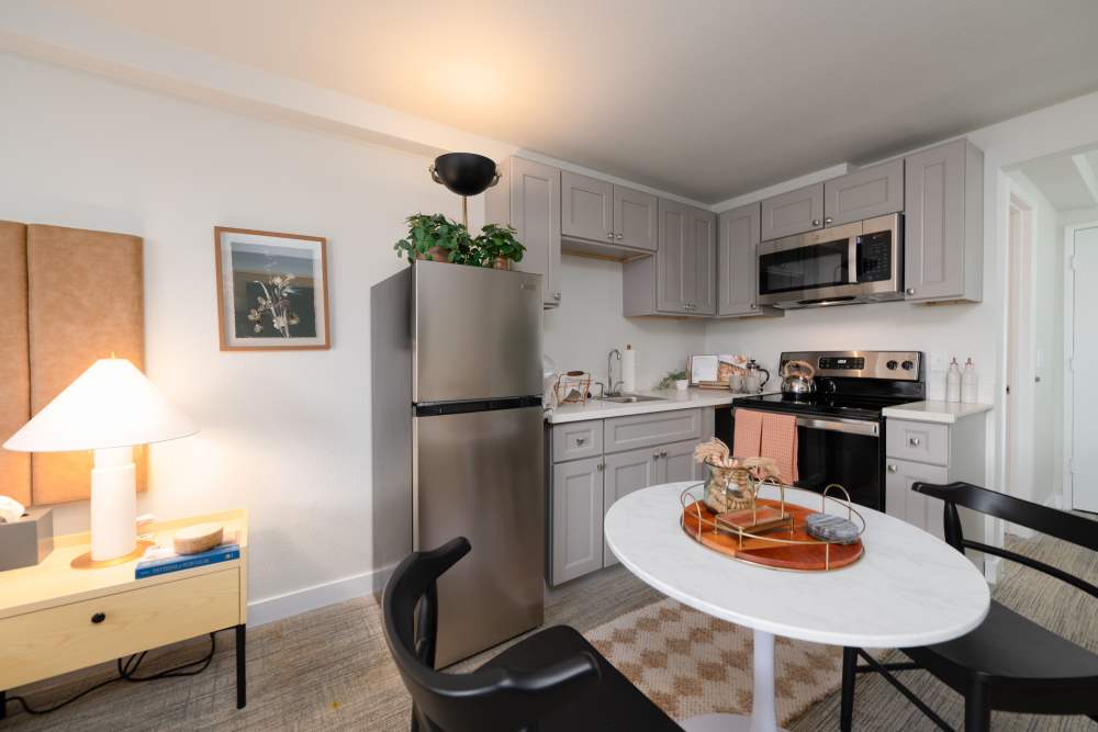 Furnished model apartment home with stainless steel appliances at Thea Apartments in Tacoma, Washington.