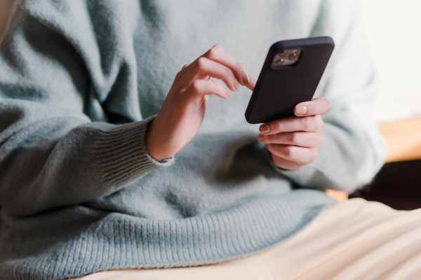 Apartment resident using phone at Kimpton in Houston, Texas
