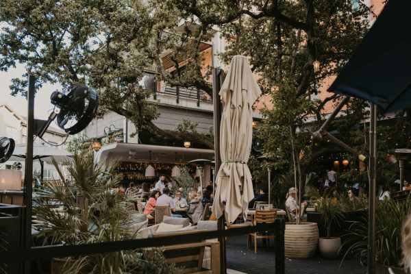 Outdoor restaurant patio with tables and chairs at Mosaic at Mueller in Austin, Texas