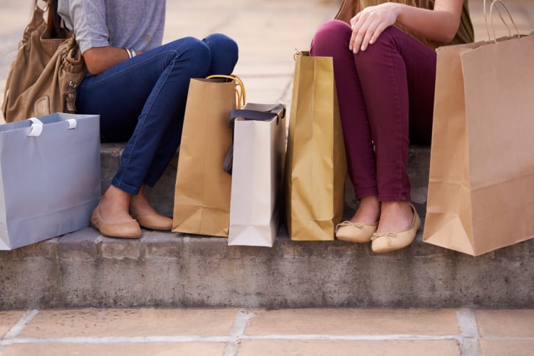 Women sitting on a step after shopping near Carriage House Apartments in Smyrna, Georgia