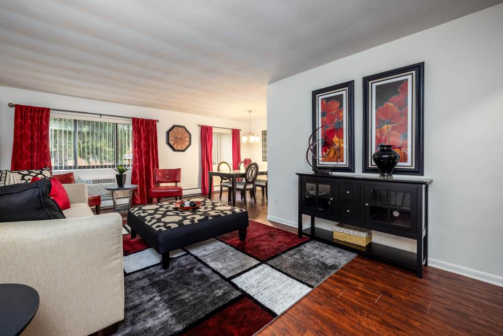 Spacious living room at Greece Commons Apartments in Rochester, New York