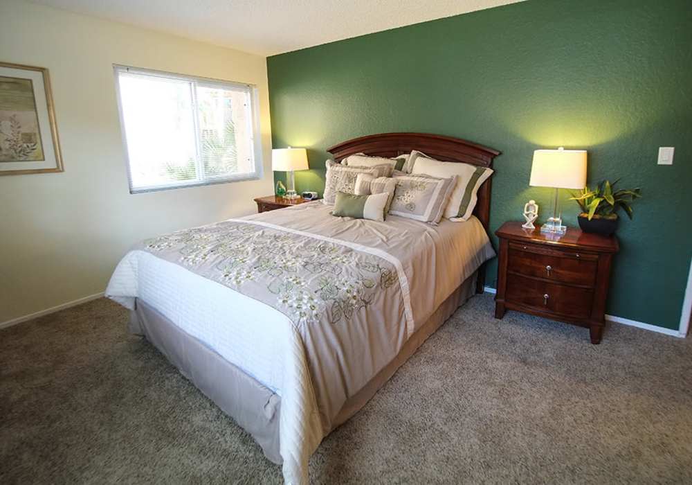 Model bedroom with carpet flooring at Villas At Camino Bernardo in San Diego, California
