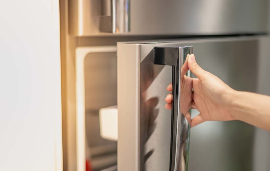 Kitchen with stainless-steel appliances at The Kensley in Spanish Fort, Alabama