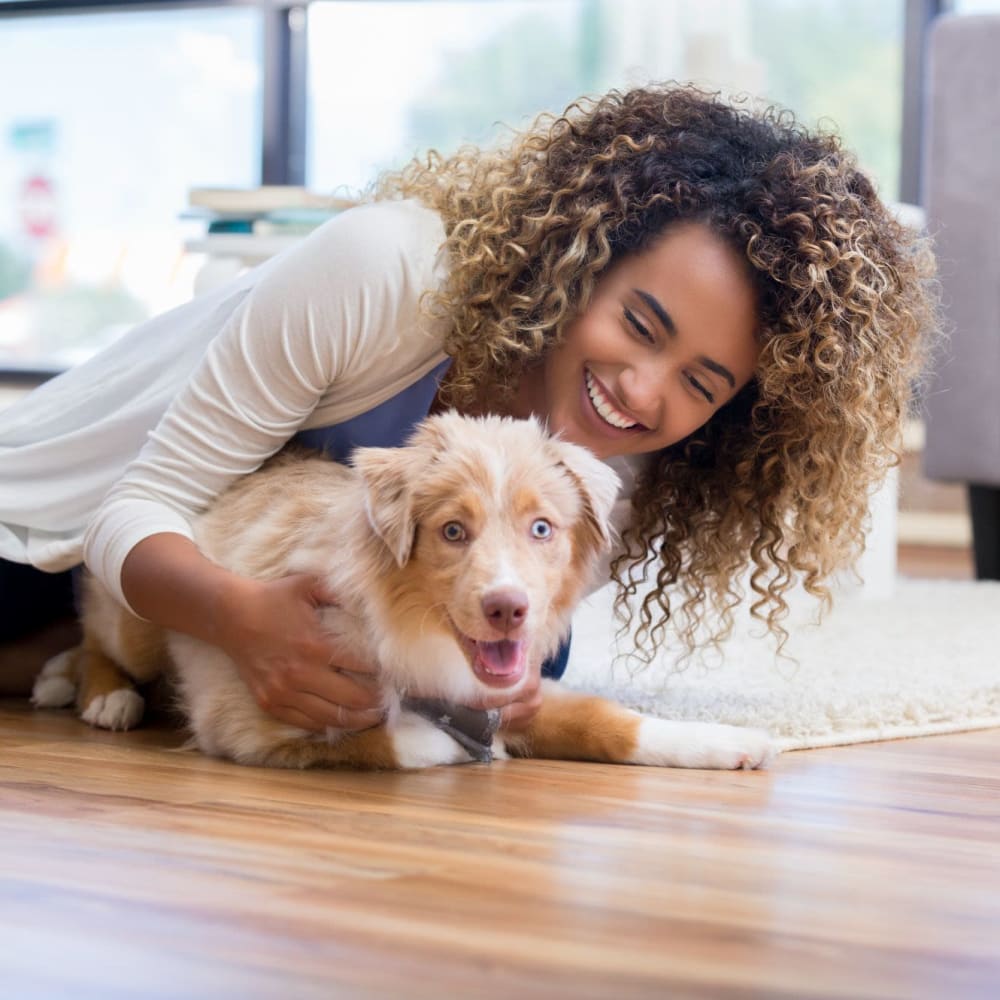 Resident with her dog in her new apartment at Ocean Palms Apartments in San Diego, California