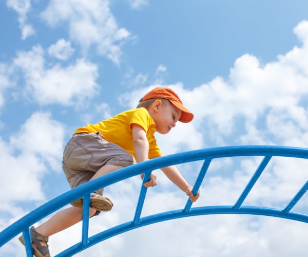 A child playing at a playground at Capeharts East in San Diego, California