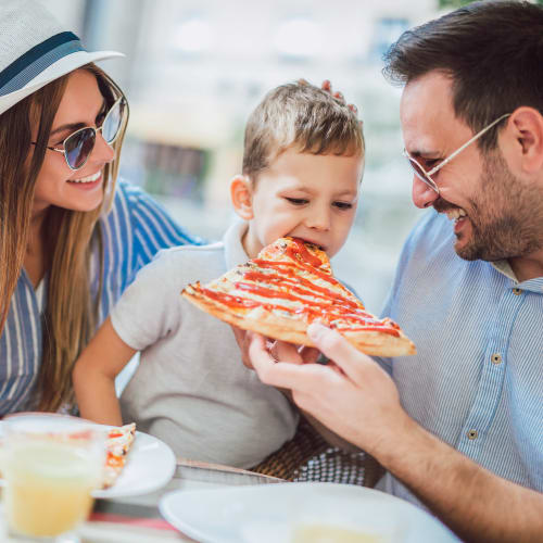 A family eating pizza near Gateway Village in San Diego, California