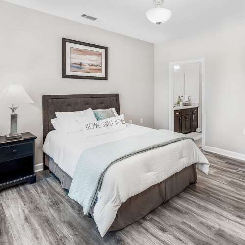 Bedroom with Wood-style Flooring at Groves at Waters Edge in Waynesville, North Carolina