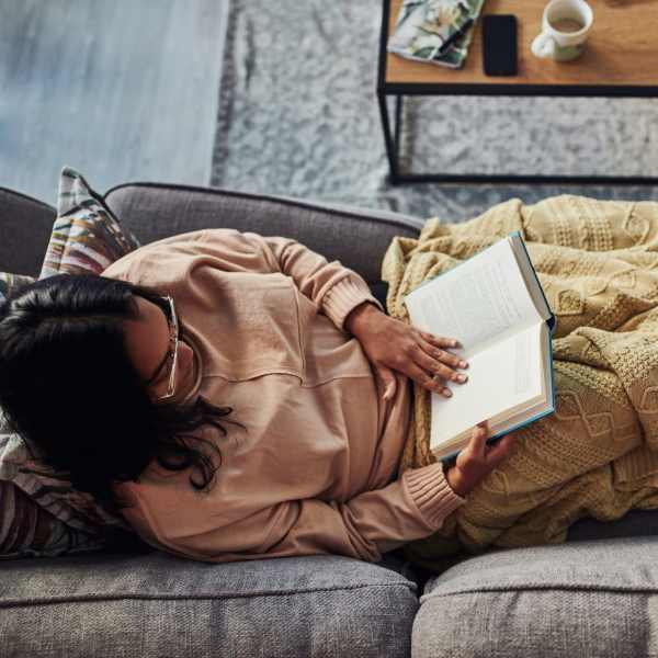 Resident cozied up with a book at Attain at Towne Centre in Fredericksburg, Virginia