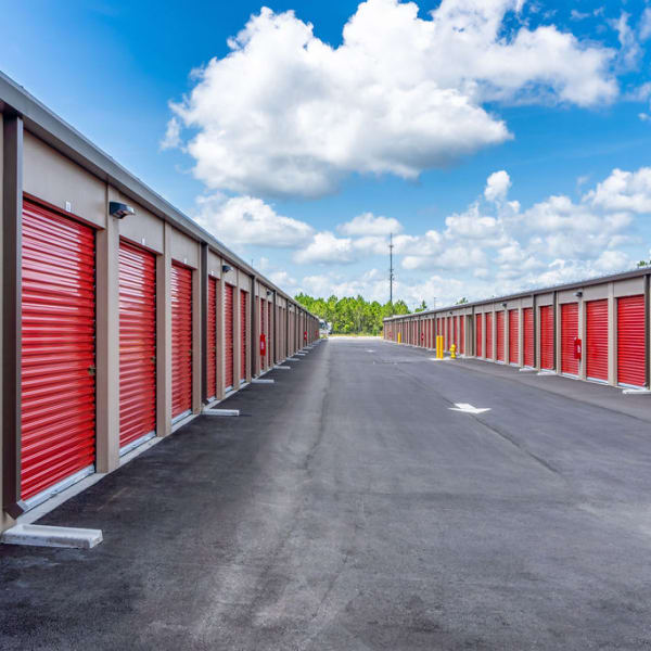 Outdoor storage units with red doors at StorQuest Self Storage in Lakeland, Florida