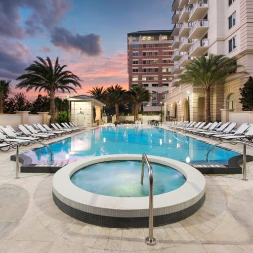 Spa and swimming pool flanked by lounge chairs at Olympus Harbour Island in Tampa, Florida