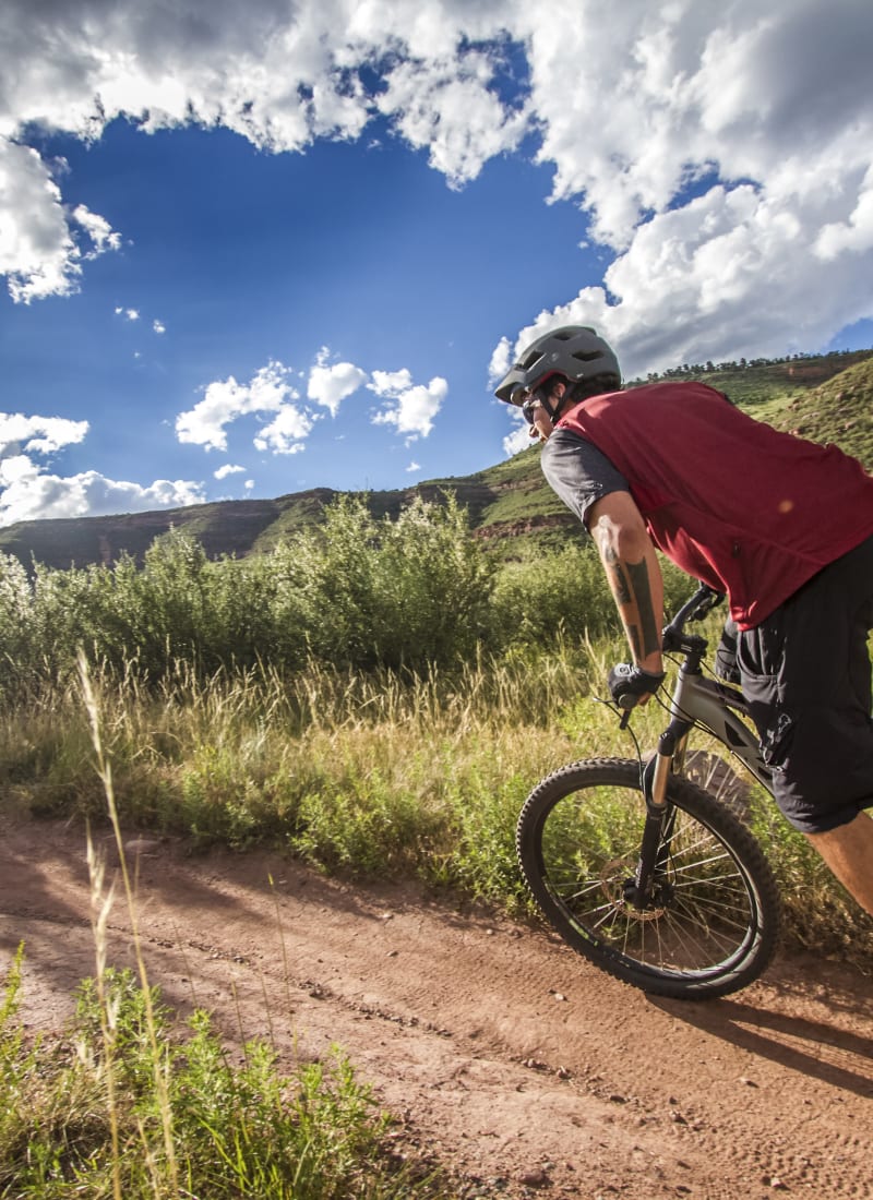 Resident riding their bike near Ashford Belmar in Lakewood, Colorado